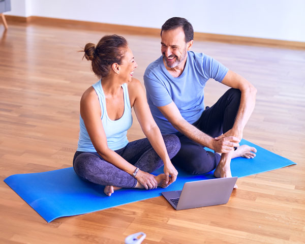 two people sitting on floor laughing