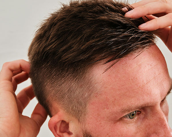 Man combing hair close up